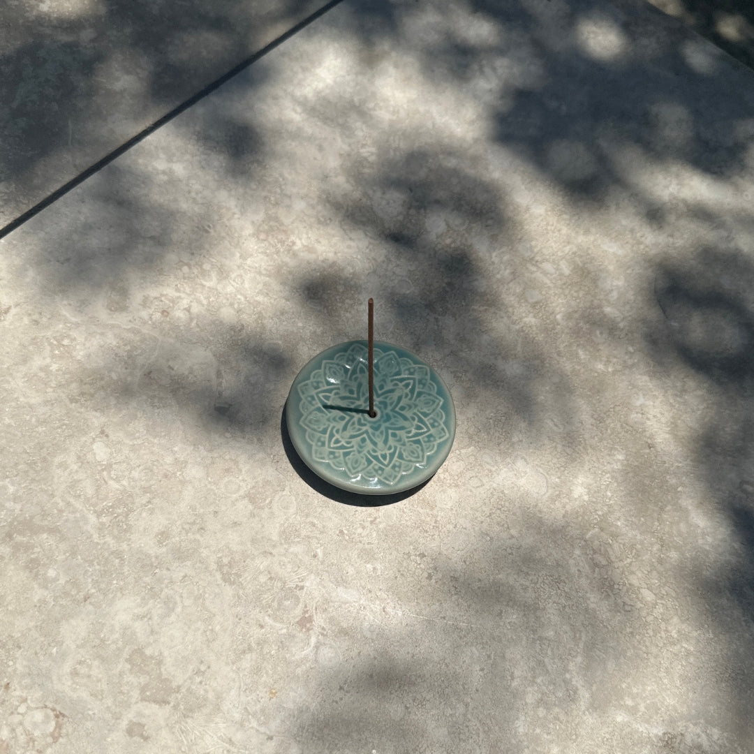 Blooming Lotus Incense Disc with incense stick in outdoor dappled light