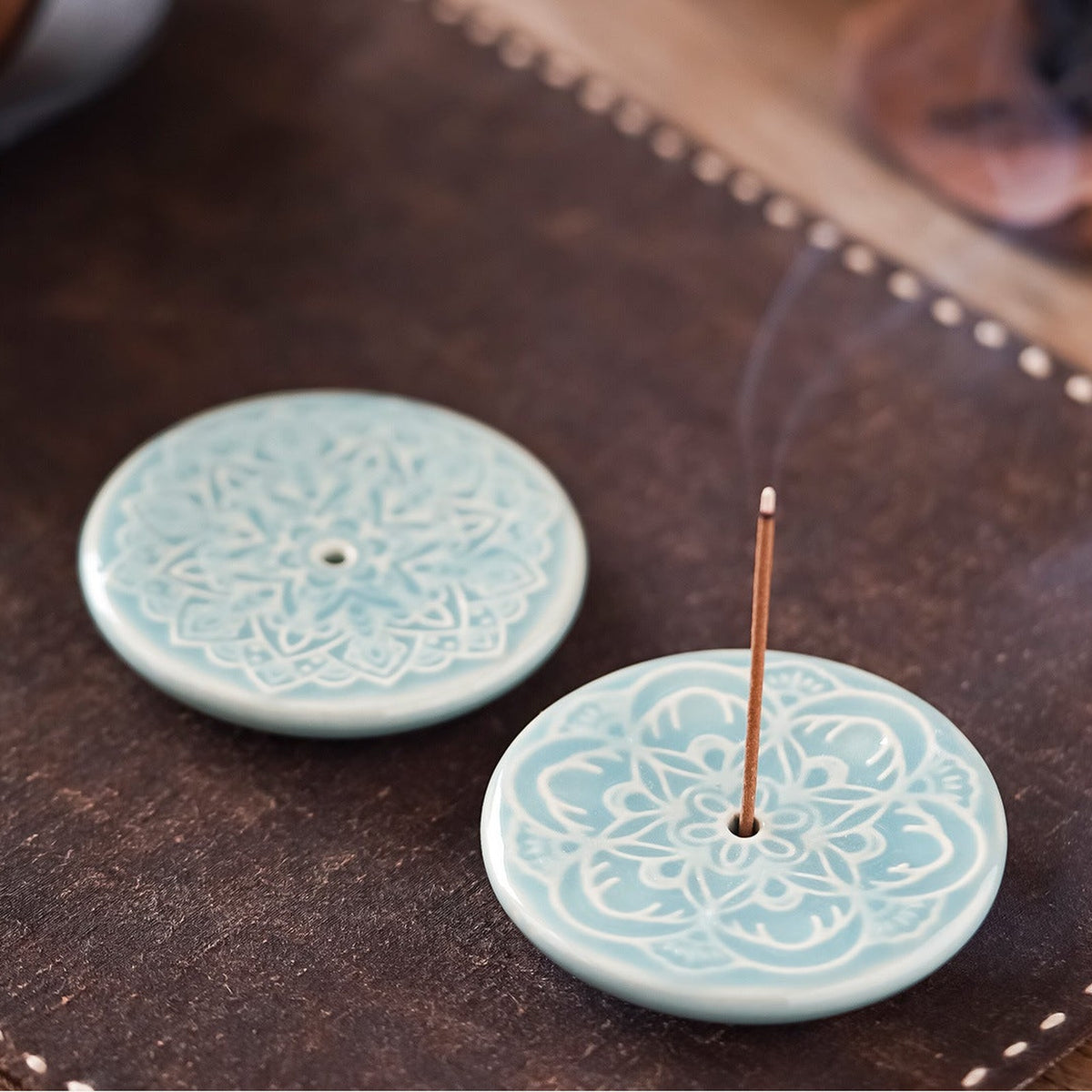 Blooming Lotus Incense Disc close-up showing celadon glaze and raised lotus relief