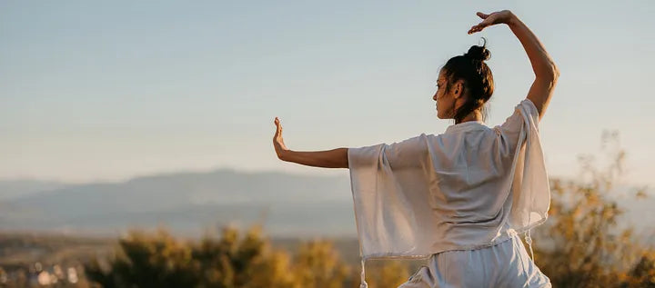 Woman stretching outdoors in warm mountain light