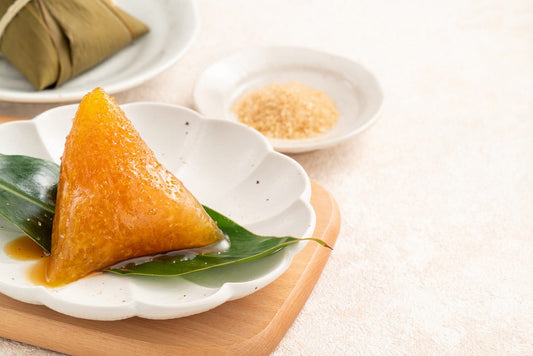 Zongzi rice dumpling and summer wellness herbs on a table