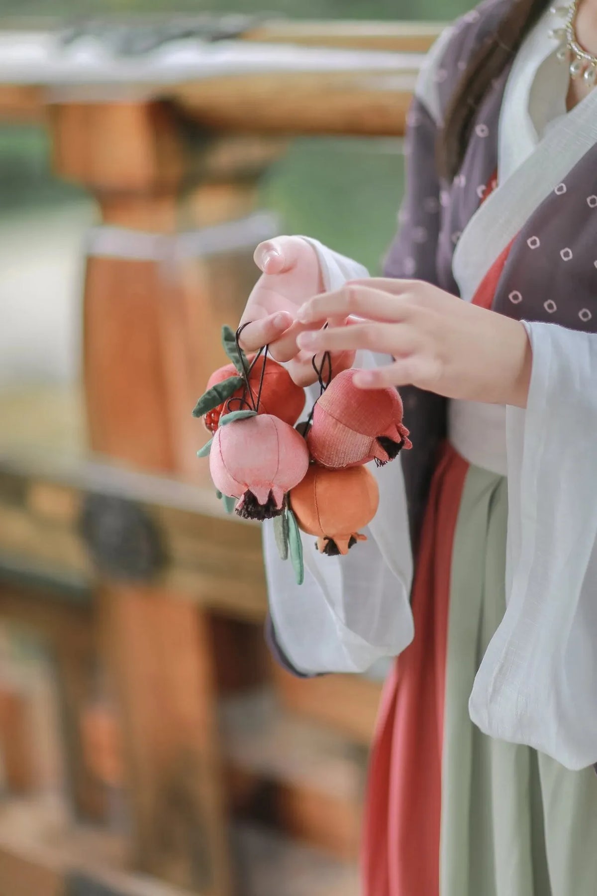 Chinese scented sachet held at a wooden doorway