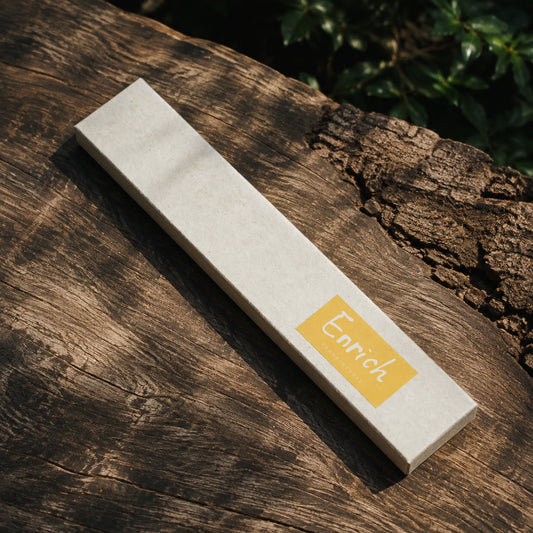 Enrich Frankincense Incense box on weathered wood in dappled sunlight