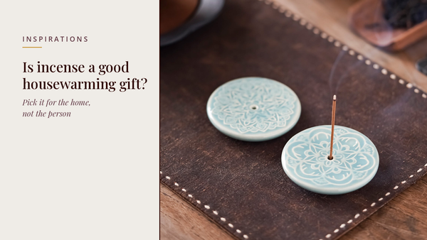 INCENZO blog header — Is incense a good housewarming gift — two celadon lotus incense discs with a lit stick on a leather mat