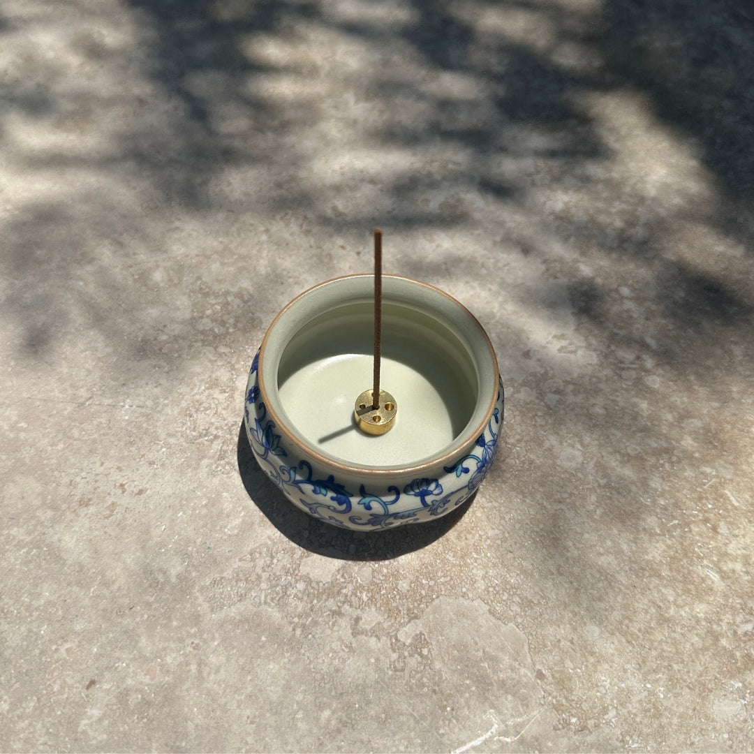 Ru Ware Lotus Incense Burner - Blue-and-White Vine on stone surface with incense stick