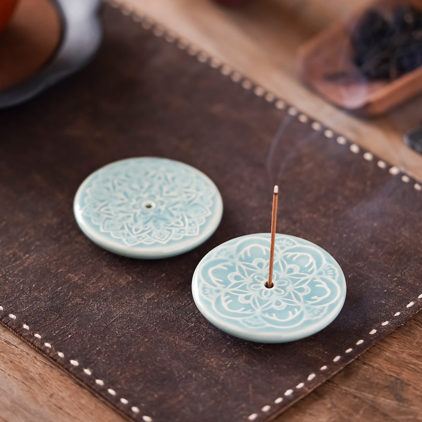 Close-up of Blooming Lotus Incense Disc showing celadon glaze and raised lotus petals