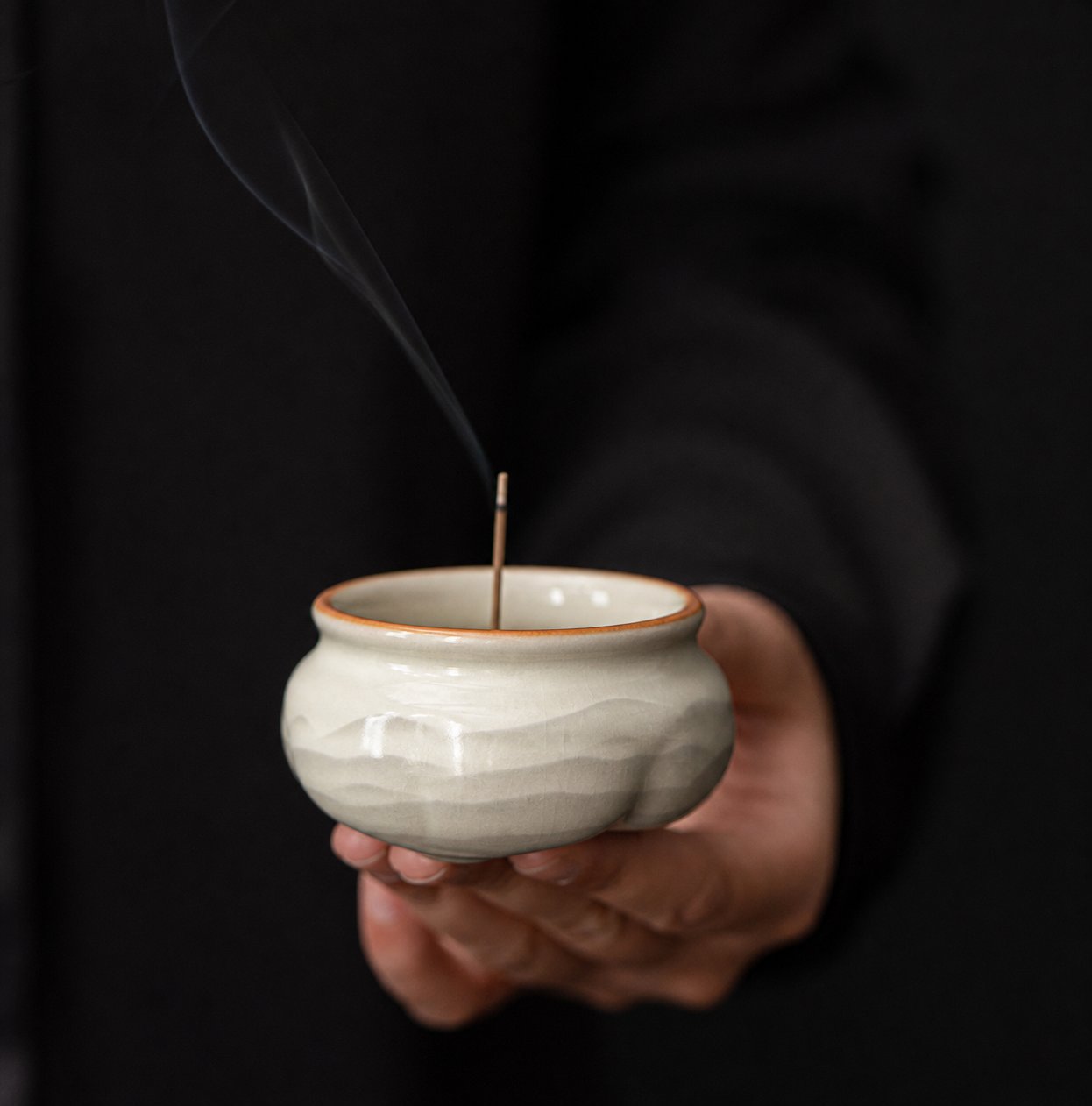 Ru Ware Lotus Incense Burner - Celadon Cream held by hand with incense smoke