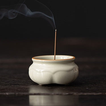 Ru Ware Lotus Incense Burner - Celadon Cream with incense smoke on dark wooden table