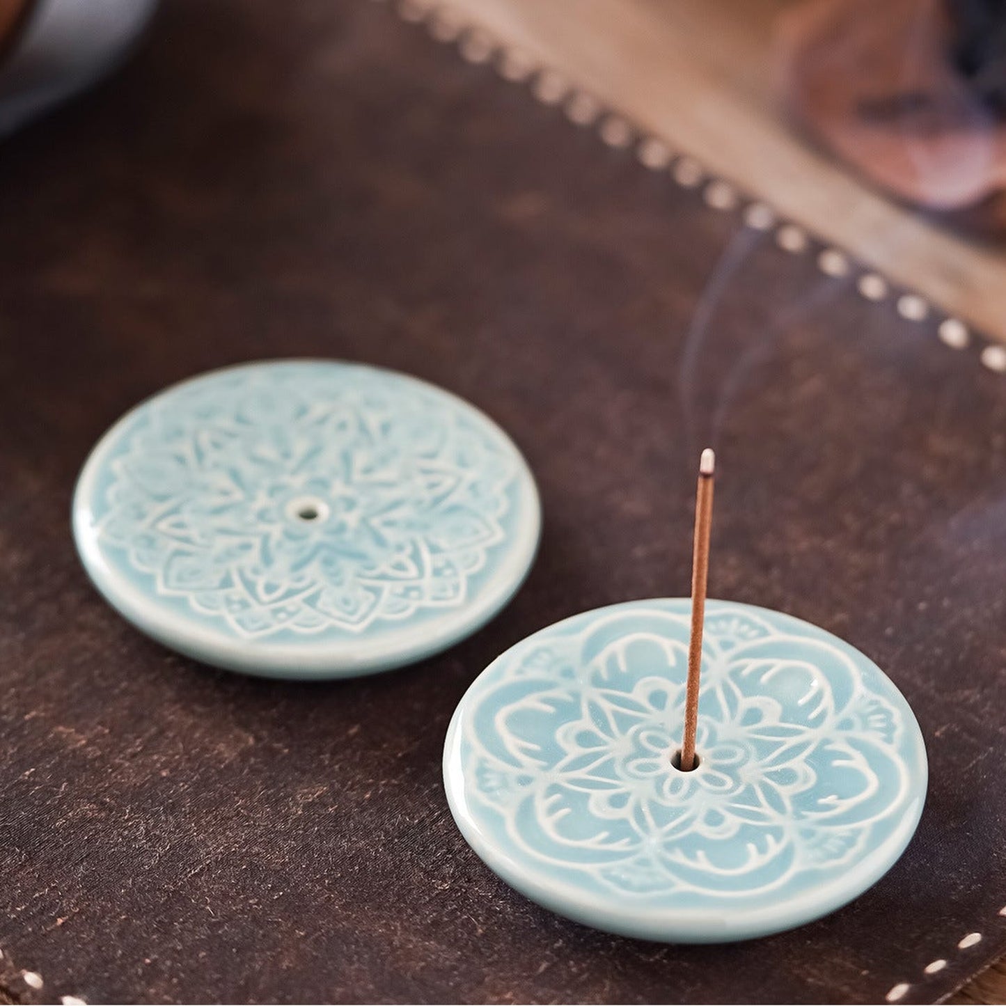 Blooming Lotus Incense Disc close-up showing celadon glaze and raised lotus relief
