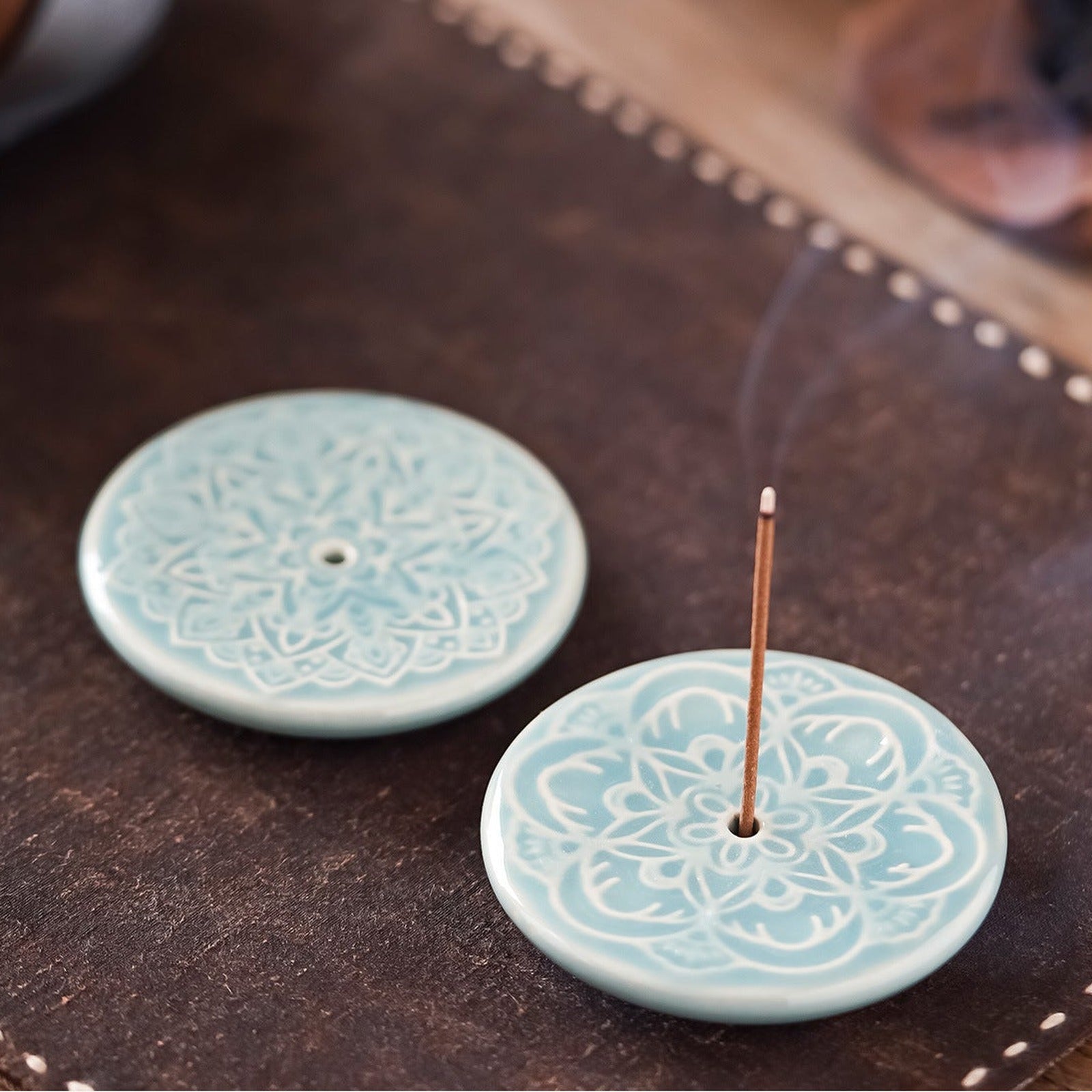Blooming Lotus Incense Disc close-up showing celadon glaze and raised lotus relief