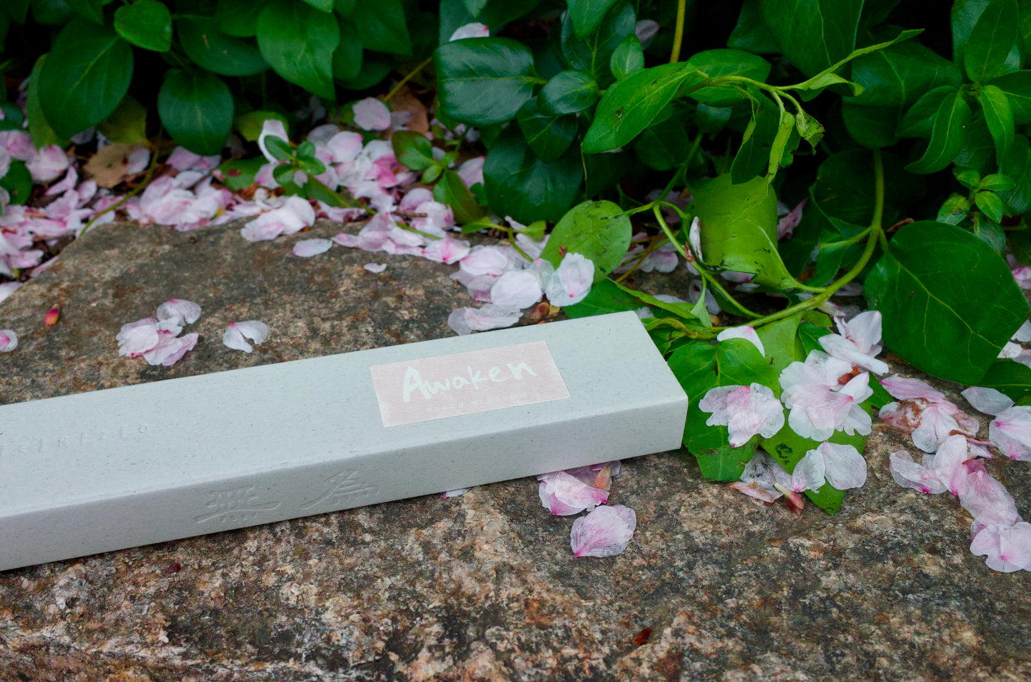 peach blossom incense with pink flower pedals and green leaves